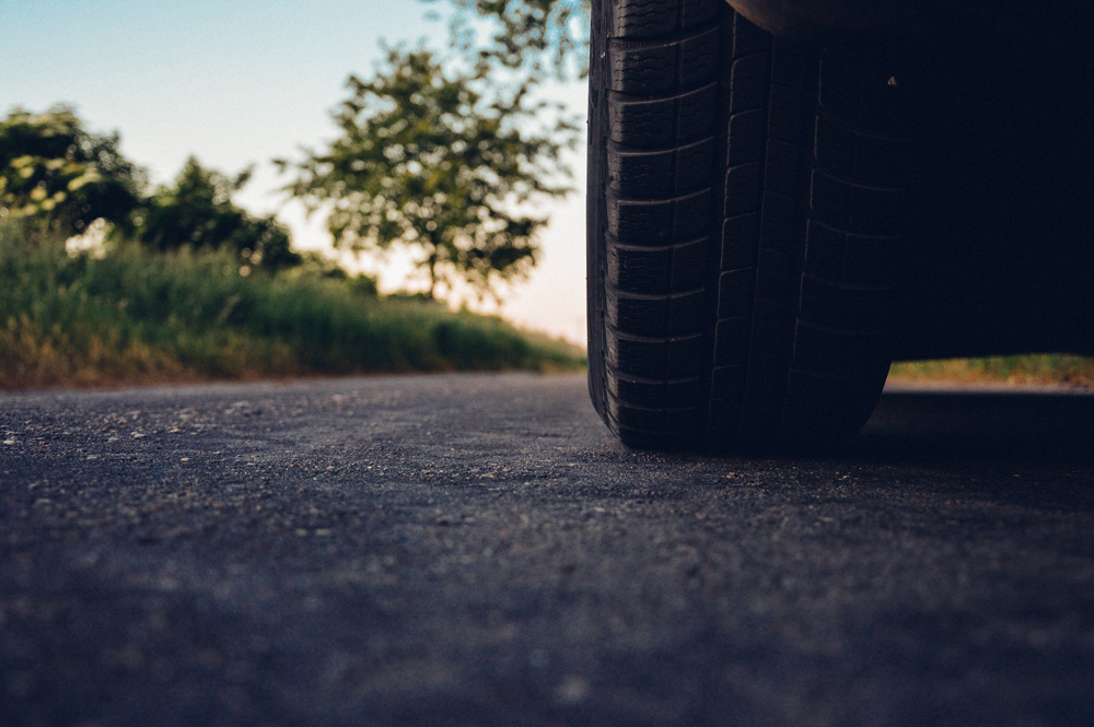 zoomed in view of car tire on street