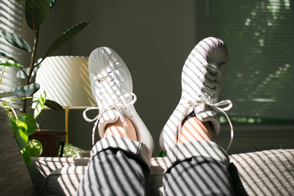 lounging in apartment with feet hanging off couch