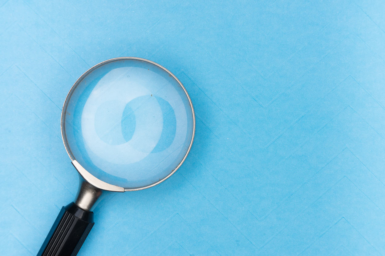 magnifying glass on a blue table