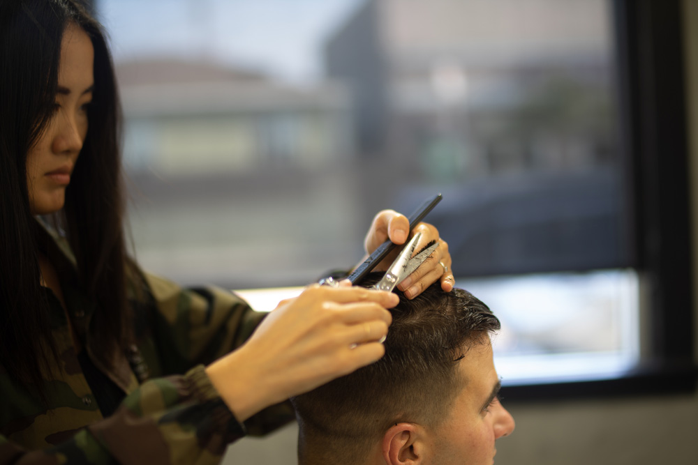 hairstylist giving man a haircut