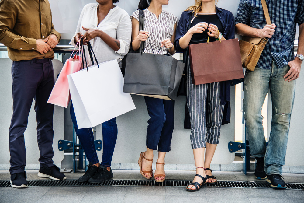 group of people holding shopping bags