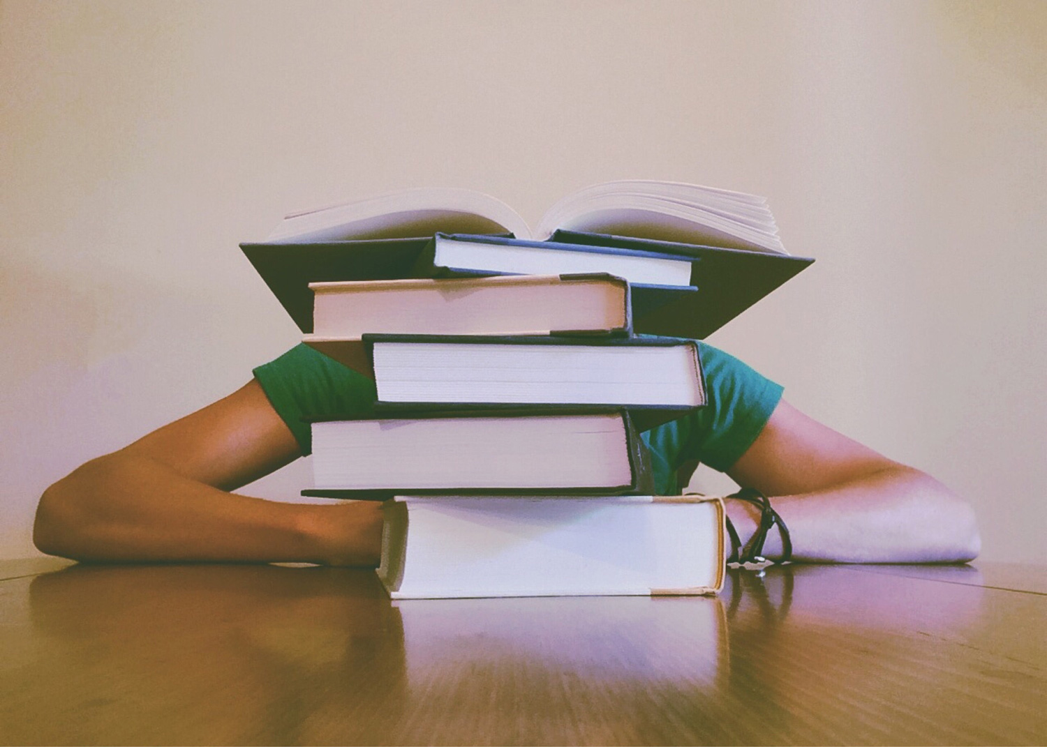 person sitting behind books