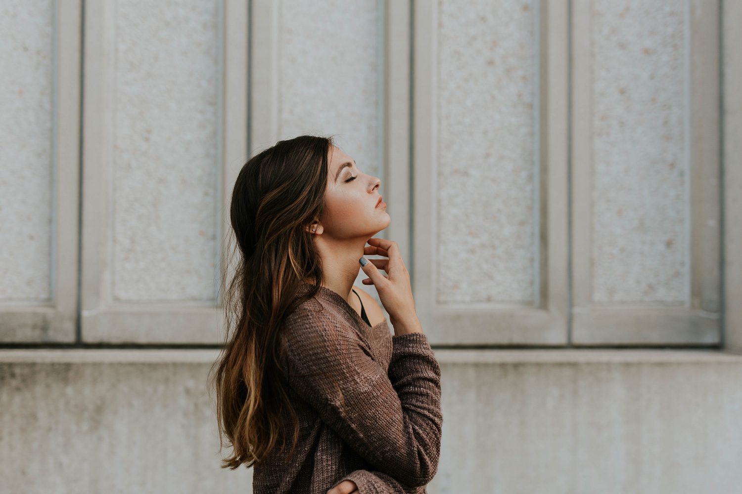 woman standing beside a wall